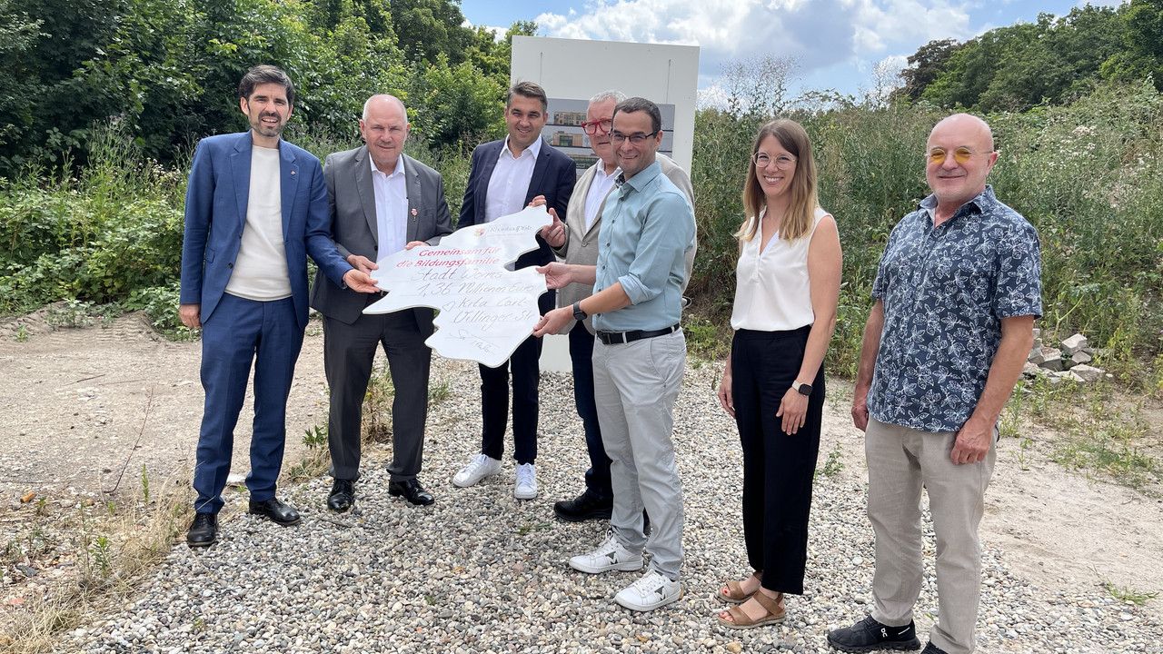 Zu sehen ist Bildungsminister Teuber mit Vertreterinnen und Vertretern der Kommune sowie der Kita während der Bescheidübergabe.